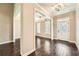 Well-lit foyer with coffered ceiling, hardwood floors, and an elegantly designed front door at 46 Grand Georgian Ne Ct, Cartersville, GA 30121