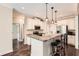 Beautiful open kitchen with white cabinetry, granite countertops, stainless appliances and hardwood floors at 46 Grand Georgian Ne Ct, Cartersville, GA 30121