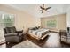 Spacious bedroom with a ceiling fan, ample natural light, and hardwood floors at 46 Grand Georgian Ne Ct, Cartersville, GA 30121