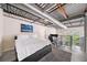 Open loft bedroom featuring a large bed, workspace, and industrial-style ceiling at 572 Edgewood Se Ave # 303, Atlanta, GA 30312