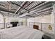 Open loft bedroom with industrial ceiling detail and a modern railing overlooking the living area at 572 Edgewood Se Ave # 303, Atlanta, GA 30312