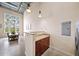 This kitchen features a granite countertop bar and stainless steel refrigerator next to a dining area with large windows at 572 Edgewood Se Ave # 303, Atlanta, GA 30312