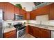 This kitchen features wood cabinetry, granite countertops, and stainless steel appliances at 572 Edgewood Se Ave # 303, Atlanta, GA 30312