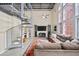 Bright living room featuring a spiral staircase, high ceilings, large windows, and a comfortable sofa at 572 Edgewood Se Ave # 303, Atlanta, GA 30312