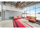 Bright living room with exposed ceiling, gray accent wall, floor to ceiling windows, and modern furniture at 572 Edgewood Se Ave # 303, Atlanta, GA 30312