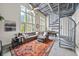 Bright living room with large windows, a comfortable sofa, and unique architectural details at 572 Edgewood Se Ave # 303, Atlanta, GA 30312