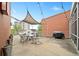 Outdoor patio area with string lights, table, chairs, and a grill at 572 Edgewood Se Ave # 303, Atlanta, GA 30312