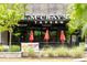 Exterior view of McCray's Tavern, featuring red umbrellas and outdoor seating at 572 Edgewood Se Ave # 303, Atlanta, GA 30312