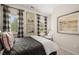 Cozy bedroom featuring a comfortable armchair near bright windows with patterned curtains at 106 Jacobs Farm Ln # 42, Lawrenceville, GA 30045