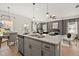 Spacious kitchen featuring granite countertops, stainless steel appliances, a central island with bar seating, and an open living area at 106 Jacobs Farm Ln # 42, Lawrenceville, GA 30045