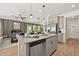 Well-equipped kitchen featuring granite countertops, stainless steel appliances, a central island with seating, and an adjacent living room at 106 Jacobs Farm Ln # 42, Lawrenceville, GA 30045