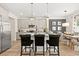 Stylish kitchen with stainless steel appliances, granite countertops, central island with seating, and adjacent dining area at 106 Jacobs Farm Ln # 42, Lawrenceville, GA 30045