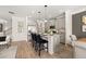 Open-concept kitchen featuring stainless steel appliances, granite countertops, central island with seating, and a cozy living space at 106 Jacobs Farm Ln # 42, Lawrenceville, GA 30045