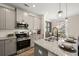 Modern kitchen featuring granite countertops, stainless steel appliances, a central island with seating, and ample cabinet space at 106 Jacobs Farm Ln # 42, Lawrenceville, GA 30045