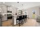 Modern kitchen featuring stainless steel appliances, granite countertops, a central island with bar seating, and a dining area at 106 Jacobs Farm Ln # 42, Lawrenceville, GA 30045