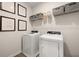 Efficient laundry room with modern washer and dryer units and functional shelving at 106 Jacobs Farm Ln # 42, Lawrenceville, GA 30045