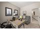 Well-lit office featuring neutral walls, a modern chair, artwork, and a visible hallway at 106 Jacobs Farm Ln # 42, Lawrenceville, GA 30045