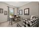 Inviting home office with a wooden desk, artwork, and a stylish black and white patterned chair at 106 Jacobs Farm Ln # 42, Lawrenceville, GA 30045