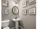 Elegant powder room showcasing modern fixtures, a pedestal sink, and stylish wall art at 106 Jacobs Farm Ln # 42, Lawrenceville, GA 30045