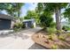 Spacious backyard featuring a detached garage, complemented by lush greenery and a long driveway at 1228 Hosea L Williams Ne Dr, Atlanta, GA 30317