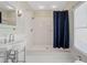 Modern bathroom with glass-shelved sink and stylish shower with large shower curtain at 1228 Hosea L Williams Ne Dr, Atlanta, GA 30317