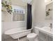 Bright bathroom featuring a classic clawfoot tub, tiled walls, and stylish fixtures at 1228 Hosea L Williams Ne Dr, Atlanta, GA 30317