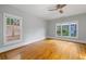 A serene bedroom filled with natural light, showcasing hardwood floors and a modern ceiling fan at 1228 Hosea L Williams Ne Dr, Atlanta, GA 30317