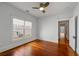 Bright, empty bedroom with hardwood floors, a ceiling fan, and natural light from the window at 1228 Hosea L Williams Ne Dr, Atlanta, GA 30317