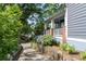 Charming home featuring a welcoming front porch with beautiful landscaping and a stone retaining wall at 1228 Hosea L Williams Ne Dr, Atlanta, GA 30317