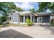 Charming home exterior showcasing a well-maintained yard, a long driveway, and covered porch at 1228 Hosea L Williams Ne Dr, Atlanta, GA 30317