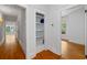 Hallway with hardwood floors, showing a glimpse into rooms and a storage space with shelves at 1228 Hosea L Williams Ne Dr, Atlanta, GA 30317