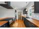 Bright and modern kitchen with black cabinets, butcher block countertops, and stainless steel appliances at 1228 Hosea L Williams Ne Dr, Atlanta, GA 30317