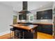 Well-appointed kitchen featuring dark cabinetry, butcher block countertops, and a sleek black range hood at 1228 Hosea L Williams Ne Dr, Atlanta, GA 30317