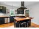 Stylish kitchen with black cabinets, butcher block countertops, stainless steel appliances, and a central island with seating at 1228 Hosea L Williams Ne Dr, Atlanta, GA 30317