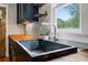 Close-up of a modern kitchen sink with a stylish faucet and butcher block countertops at 1228 Hosea L Williams Ne Dr, Atlanta, GA 30317