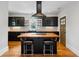 Spacious kitchen with black cabinets, butcher block countertops, a central island, and updated fixtures at 1228 Hosea L Williams Ne Dr, Atlanta, GA 30317