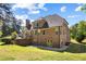 Expansive backyard with brick home, spacious lawn, and mature trees at 1614 Rucker Rd, Alpharetta, GA 30009