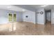 Spacious walkout basement with tile flooring, a wall-mounted television, and access to the backyard at 1614 Rucker Rd, Alpharetta, GA 30009