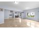 Open basement featuring tile floors, a wet bar, piano, and natural light from the windows at 1614 Rucker Rd, Alpharetta, GA 30009