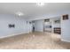 Large open basement with tile floors, tv mount, piano, and wet bar at 1614 Rucker Rd, Alpharetta, GA 30009