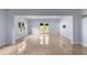 Large open basement with walkout access, tile floors, and a wall-mounted tv at 1614 Rucker Rd, Alpharetta, GA 30009