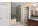 Tiled bathroom featuring a glass enclosed shower, door and vanity at 1614 Rucker Rd, Alpharetta, GA 30009