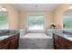Bathroom features granite countertop, dark wood cabinetry, and a relaxing soaking tub at 1614 Rucker Rd, Alpharetta, GA 30009