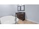 Elegant bathroom featuring double vanity, framed mirrors, and a luxurious soaking tub with modern faucet at 1614 Rucker Rd, Alpharetta, GA 30009