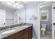 Bathroom with dual sink vanity with granite countertops and a separate toilet room at 1614 Rucker Rd, Alpharetta, GA 30009