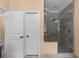 Tiled bathroom featuring a glass enclosed shower and white doors at 1614 Rucker Rd, Alpharetta, GA 30009