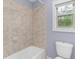 Bathroom with a bathtub and a window at 1614 Rucker Rd, Alpharetta, GA 30009