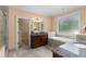 Bright bathroom featuring dual vanities, a soaking tub, and an open walk-in closet at 1614 Rucker Rd, Alpharetta, GA 30009