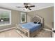 Bedroom with carpet, blue comforter, ceiling fan, and large window for lots of light at 1614 Rucker Rd, Alpharetta, GA 30009