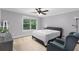 Neutral bedroom featuring a ceiling fan, plush carpet, and a large window view at 1614 Rucker Rd, Alpharetta, GA 30009